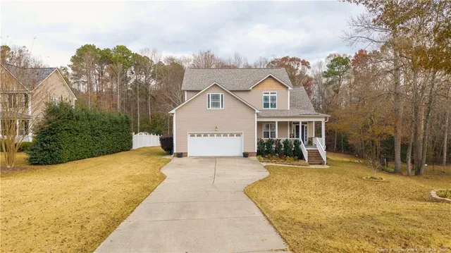 a view of house with outdoor space and sitting area