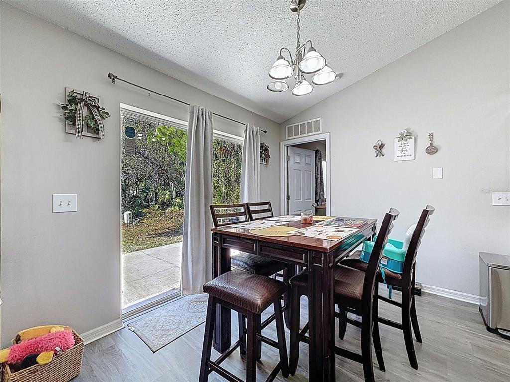 16061 Cave Swallow Road Brooksville, FL 34614 - Photo 11 of 47 a view of a dining room with furniture window and outside view