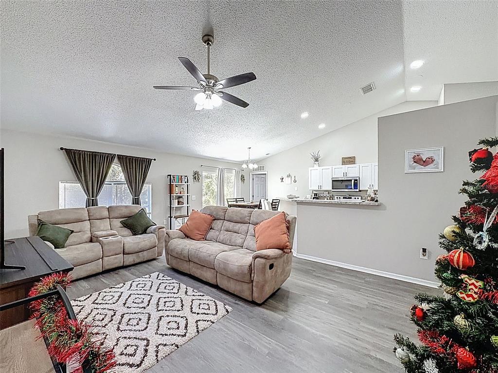 16061 Cave Swallow Road Brooksville, FL 34614 - Photo 12 of 47 a living room with furniture and flowers