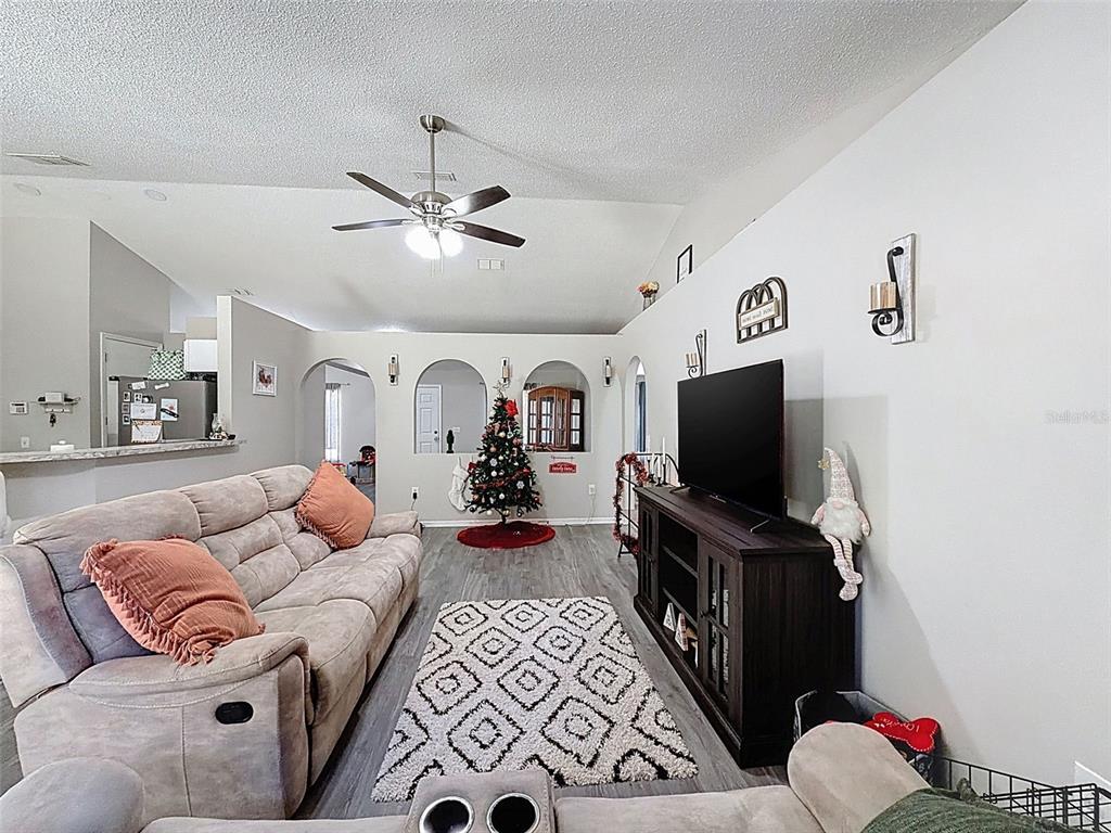 16061 Cave Swallow Road Brooksville, FL 34614 - Photo 18 of 47 a living room with furniture and a flat screen tv