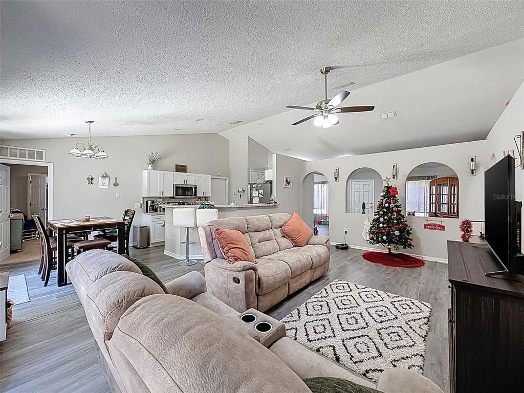16061 Cave Swallow Road Brooksville, FL 34614 - Photo 19 of 47 a living room with furniture a fireplace and flat screen tv