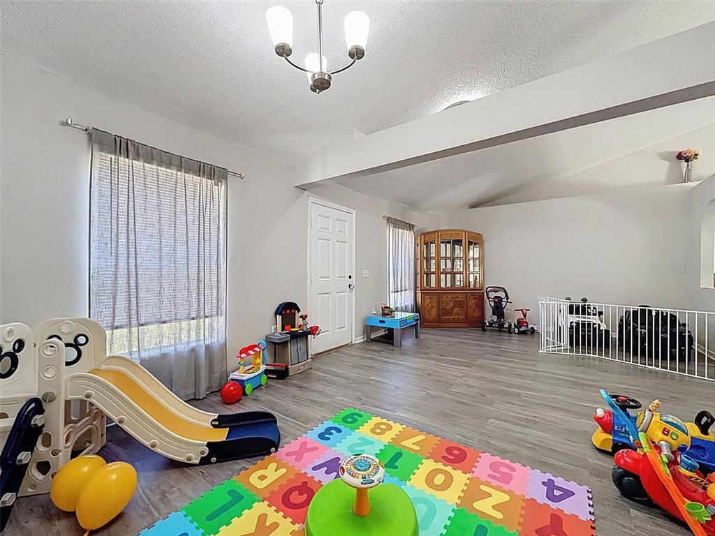 16061 Cave Swallow Road Brooksville, FL 34614 - Photo 20 of 47 a bed room with furniture and two windows