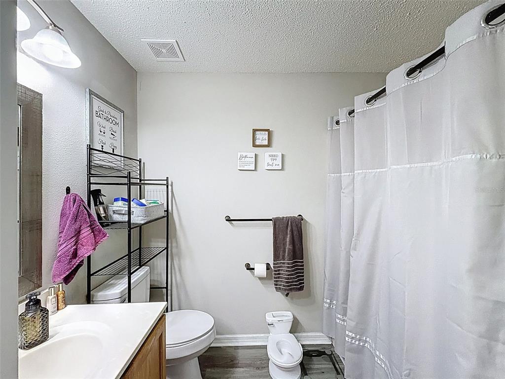 16061 Cave Swallow Road Brooksville, FL 34614 - Photo 35 of 47 a bathroom with a sink toilet and shower