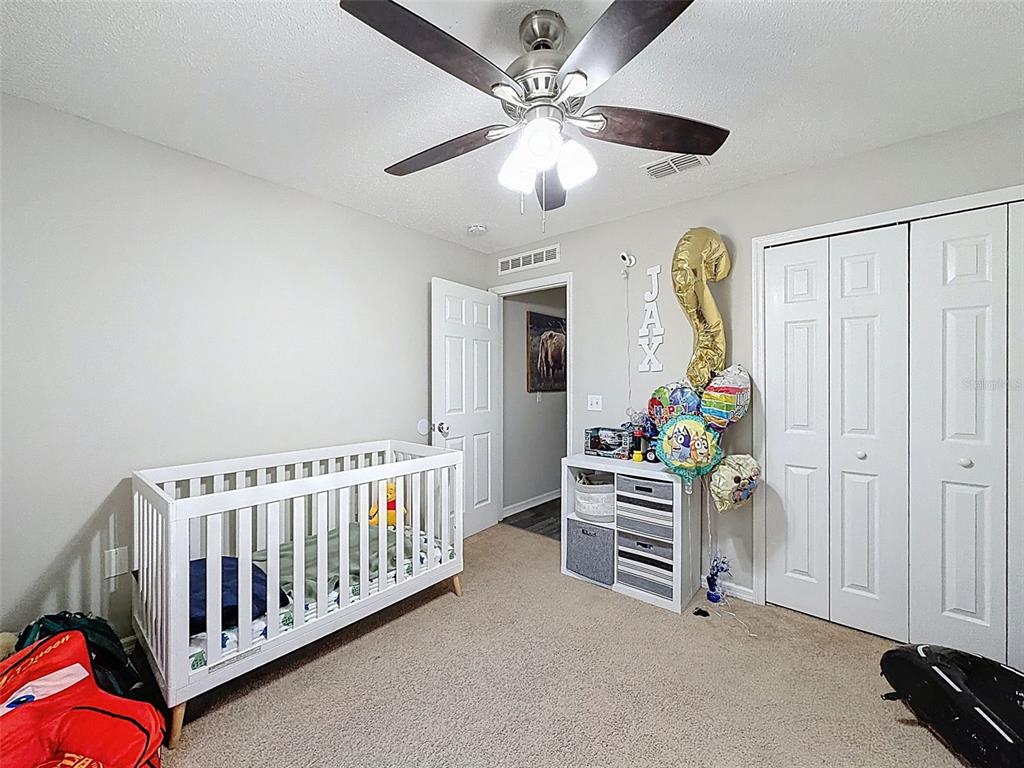 16061 Cave Swallow Road Brooksville, FL 34614 - Photo 38 of 47 a bedroom with furniture and a window