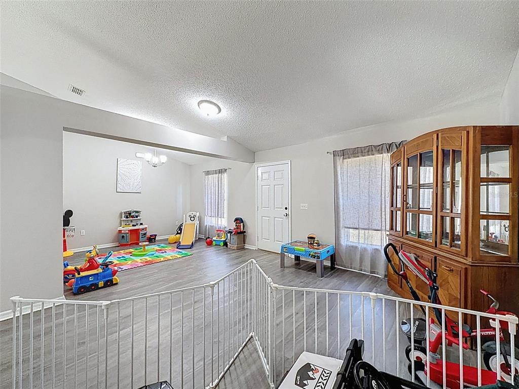 16061 Cave Swallow Road Brooksville, FL 34614 - Photo 41 of 47 a children room with furniture and toys
