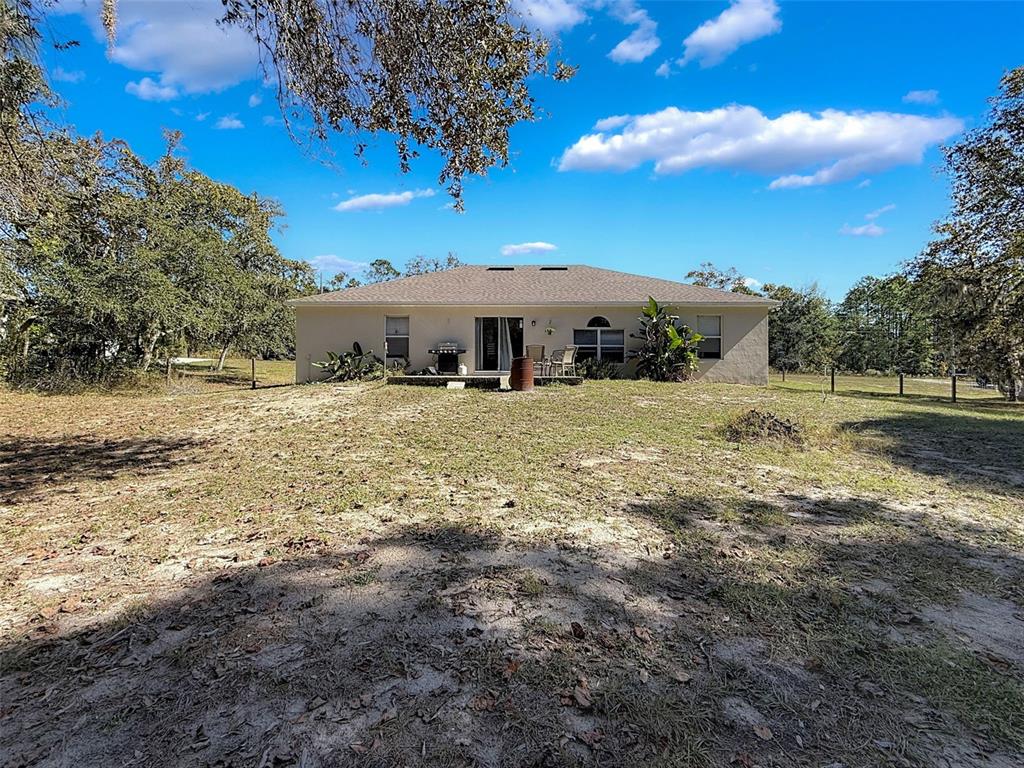 16061 Cave Swallow Road Brooksville, FL 34614 - Photo 44 of 47 a view of a yard with wooden fence
