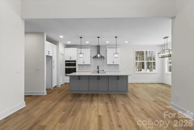a kitchen with kitchen island a sink stainless steel appliances and cabinets