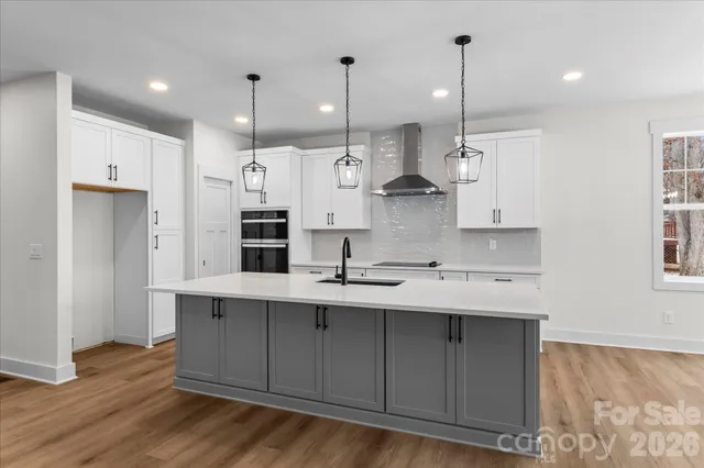a kitchen that has a sink a refrigerator and a stove