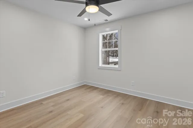 a bathroom with a granite countertop sink a mirror and a shower