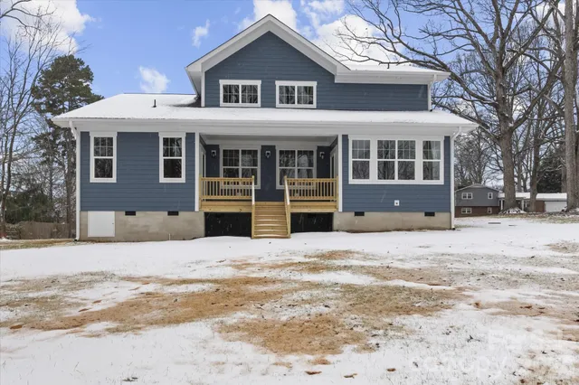 a view of a house with a yard covered in snow
