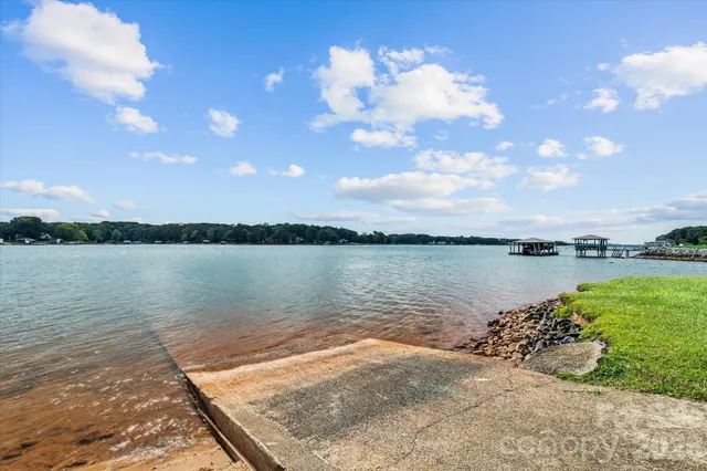 a view of a lake with houses in the back