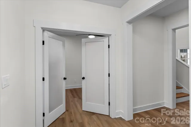 wooden floor in an empty room with a window
