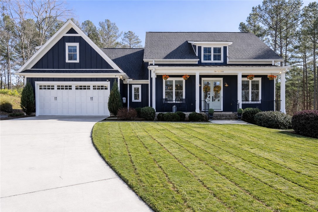 This charming home offers a welcoming facade with a well-manicured lawn and inviting entryway.