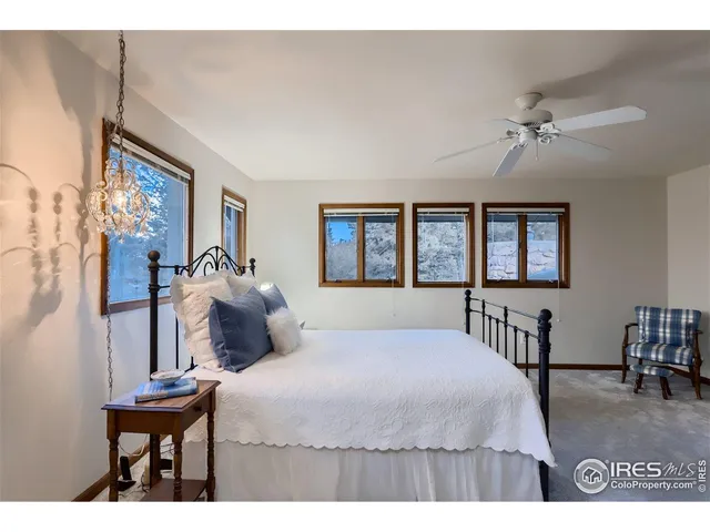 a bedroom with a bed window and a table