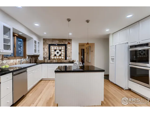 a kitchen with stainless steel appliances granite countertop a sink and cabinets