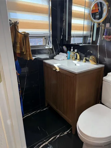 a bathroom with a sink mirror toilet and shower