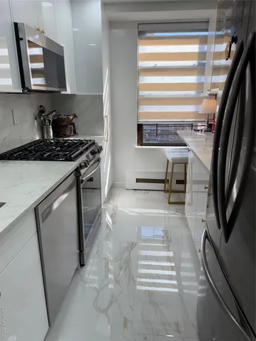 a living room with a couch and a potted plant on a shelf