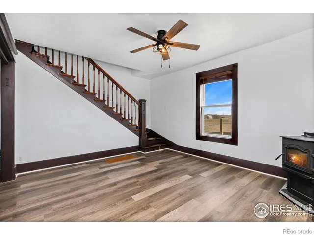 a view of an empty room and wooden floor