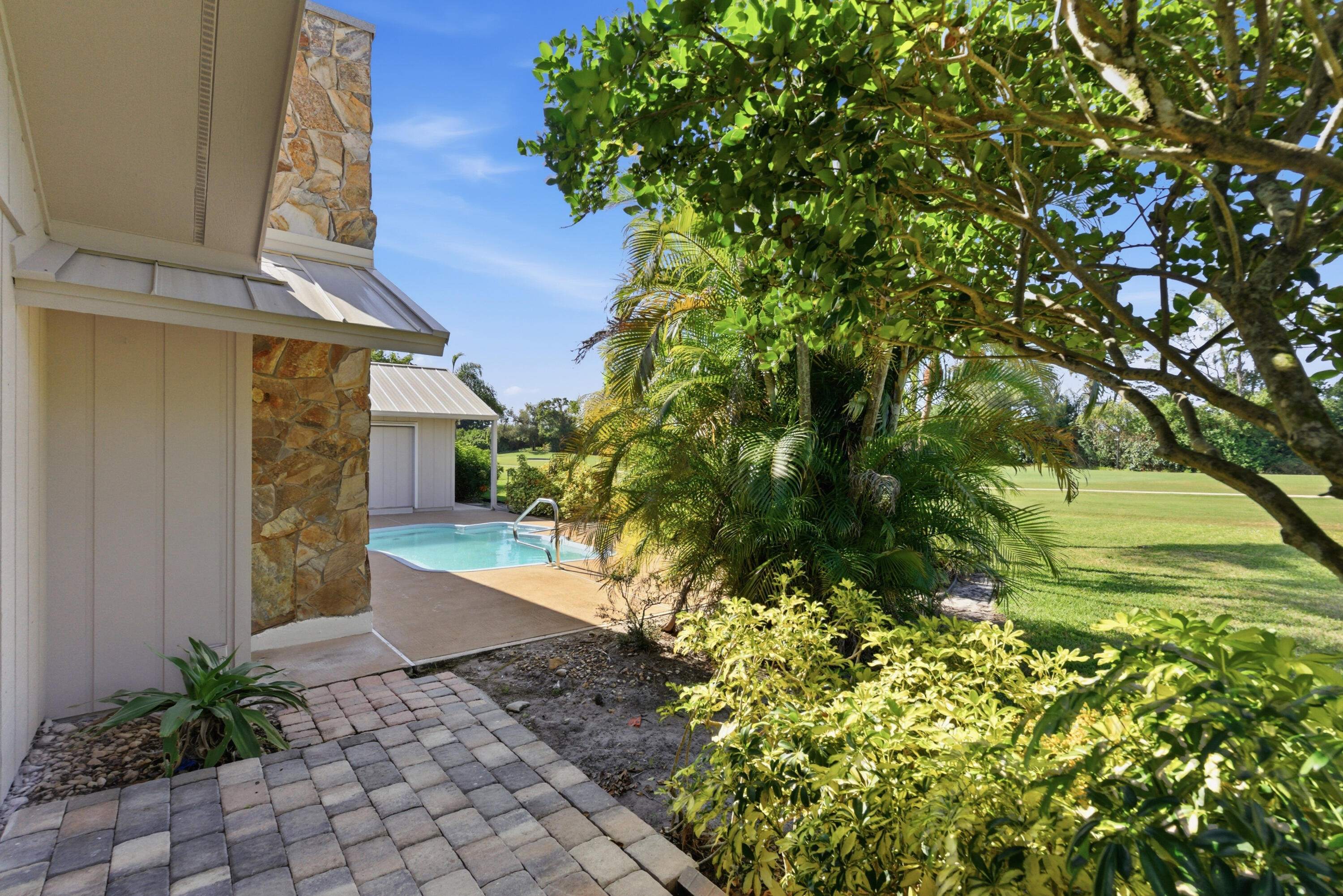 5151 Southeast Burning Tree Circle Stuart, FL 34997 - Photo 49 of 74 a view of a pathway of a house with a yard