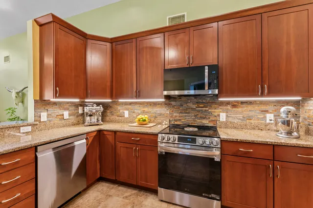 a front view of a house with a garden and patio