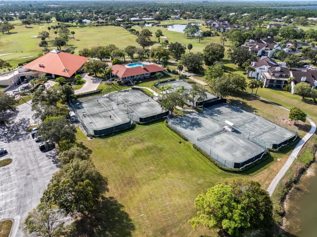 an aerial view of a house with a swimming pool yard and outdoor seating
