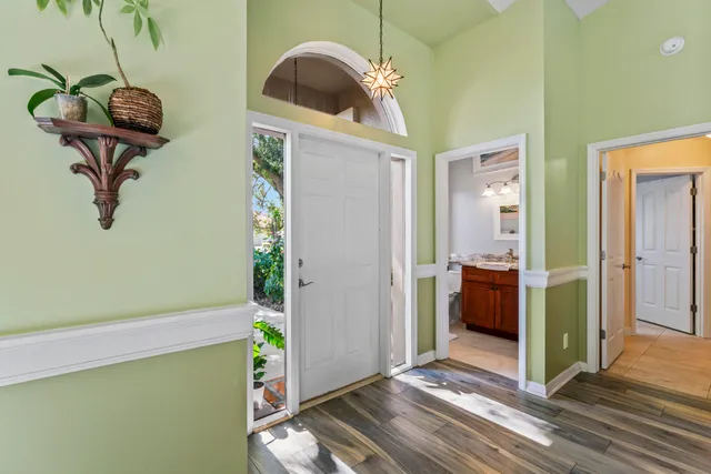 a front view of a house with a garden and yard