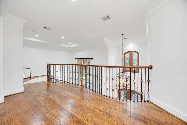 a view of a hallway with a large window and entryway