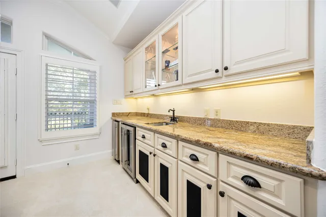 a view of a kitchen with stainless steel appliances granite countertop a stove a sink and a refrigerator