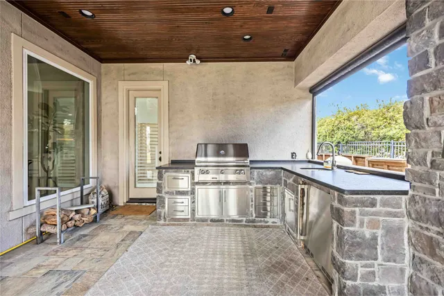 a kitchen with a stove a sink and a cabinets