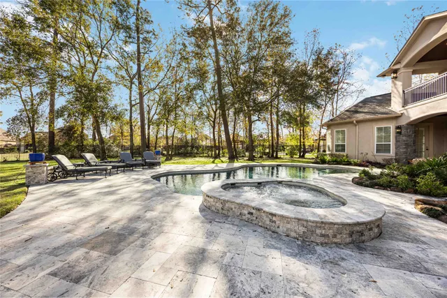 a view of swimming pool with outdoor seating and a tree