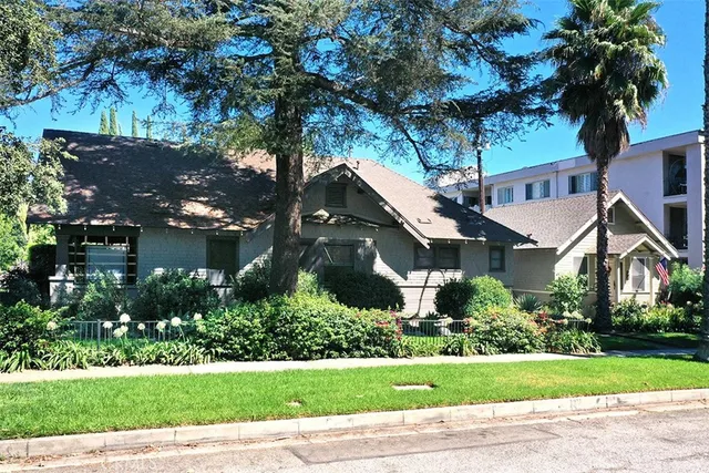 a front view of a house with a garden