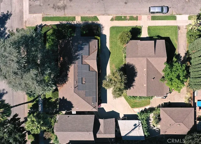 an aerial view of multiple houses with yard
