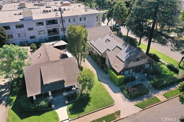 an aerial view of multiple houses with yard