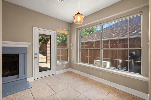 a view of an empty room with a window and a ceiling fan