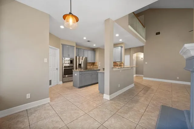 a view of kitchen with windows and refrigerator