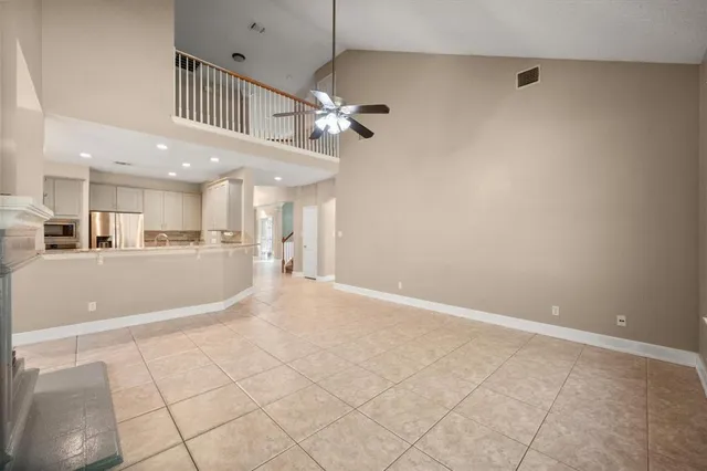 a view of an empty room and a kitchen view