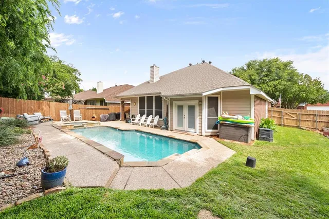a view of a house with a yard patio and swimming pool