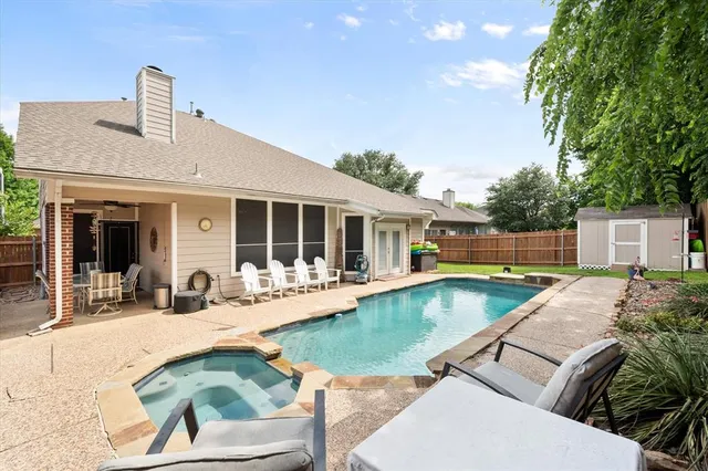 a view of a house with swimming pool and sitting area