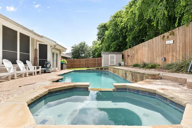 a swimming pool with outdoor seating and yard