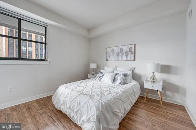 a bedroom with a bed and a window