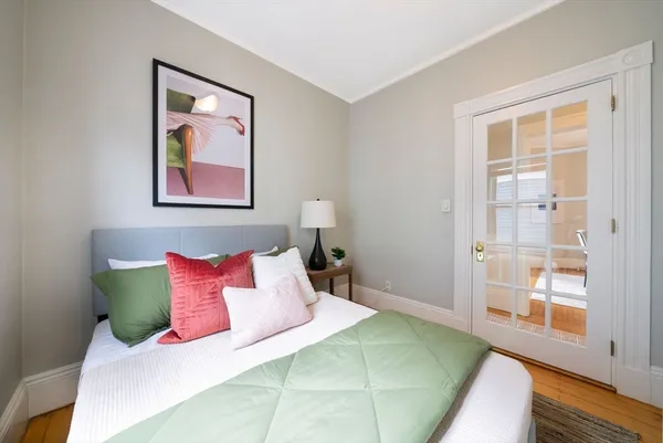 a bedroom with a bed and a painting on the wall