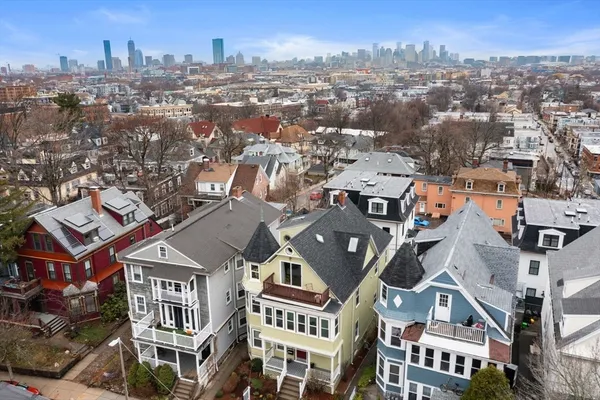 an aerial view of a residential apartment building with a yard