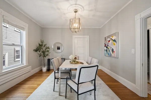 a view of a dining room with furniture wooden floor and a chandelier