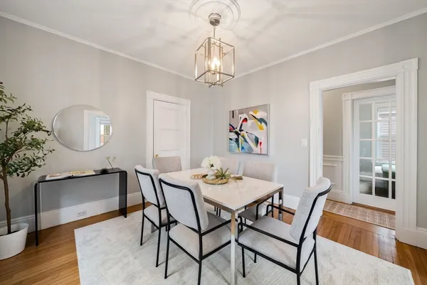 a view of a dining room with furniture wooden floor and a chandelier