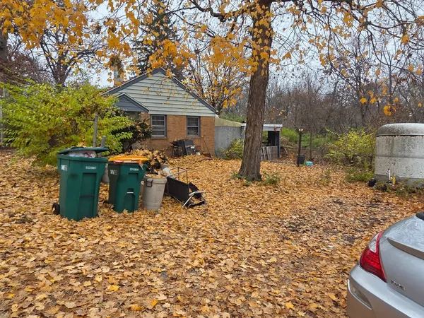 a view of a house with a yard and sitting area