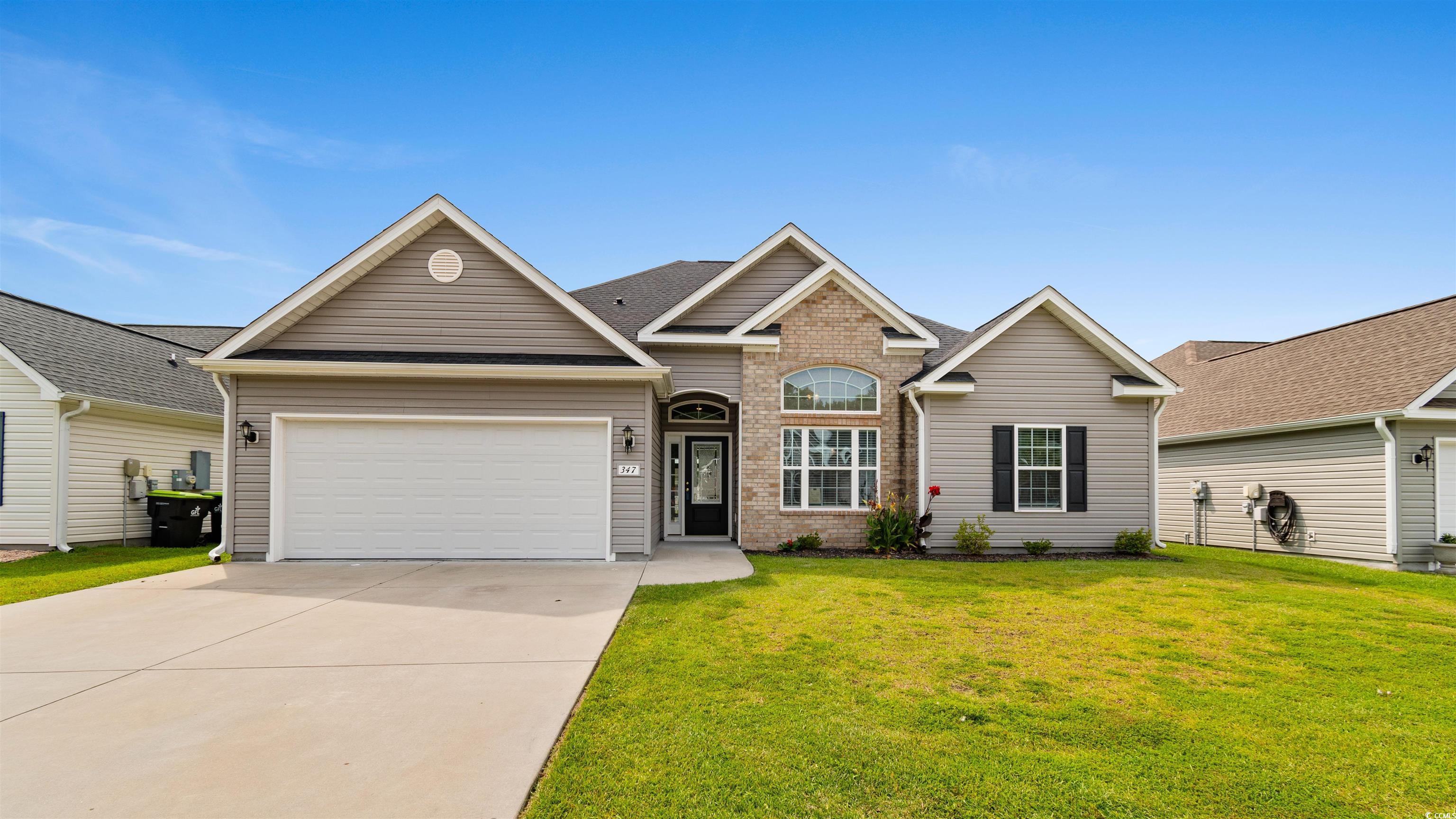 347 Leste Road Myrtle Beach, SC 29588 - Photo 1 of 32 Traditional-style house featuring driveway, a front lawn, an attached garage, and brick siding