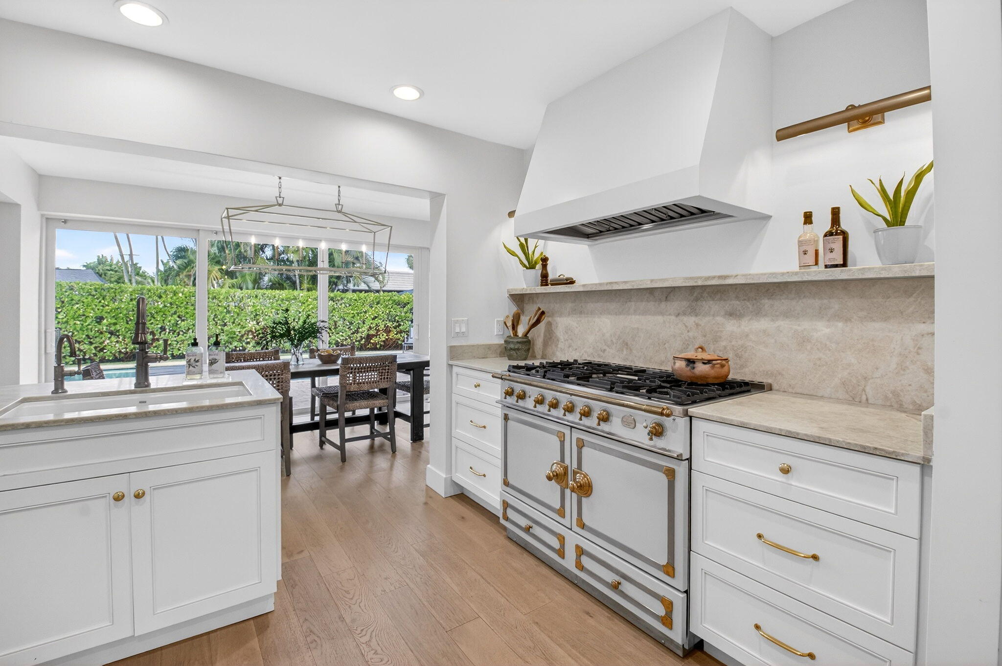 525 Sunset Road Boynton Beach, FL 33435 - Photo 13 of 62 a kitchen with stainless steel appliances white cabinets stove and sink