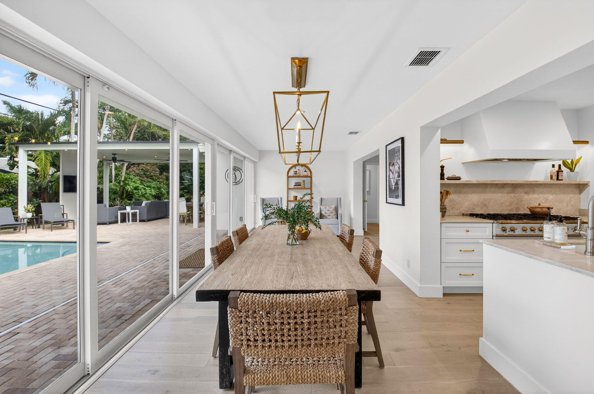 525 Sunset Road Boynton Beach, FL 33435 - Photo 20 of 62 a view of a living room and kitchen with furniture wooden floor and a rug