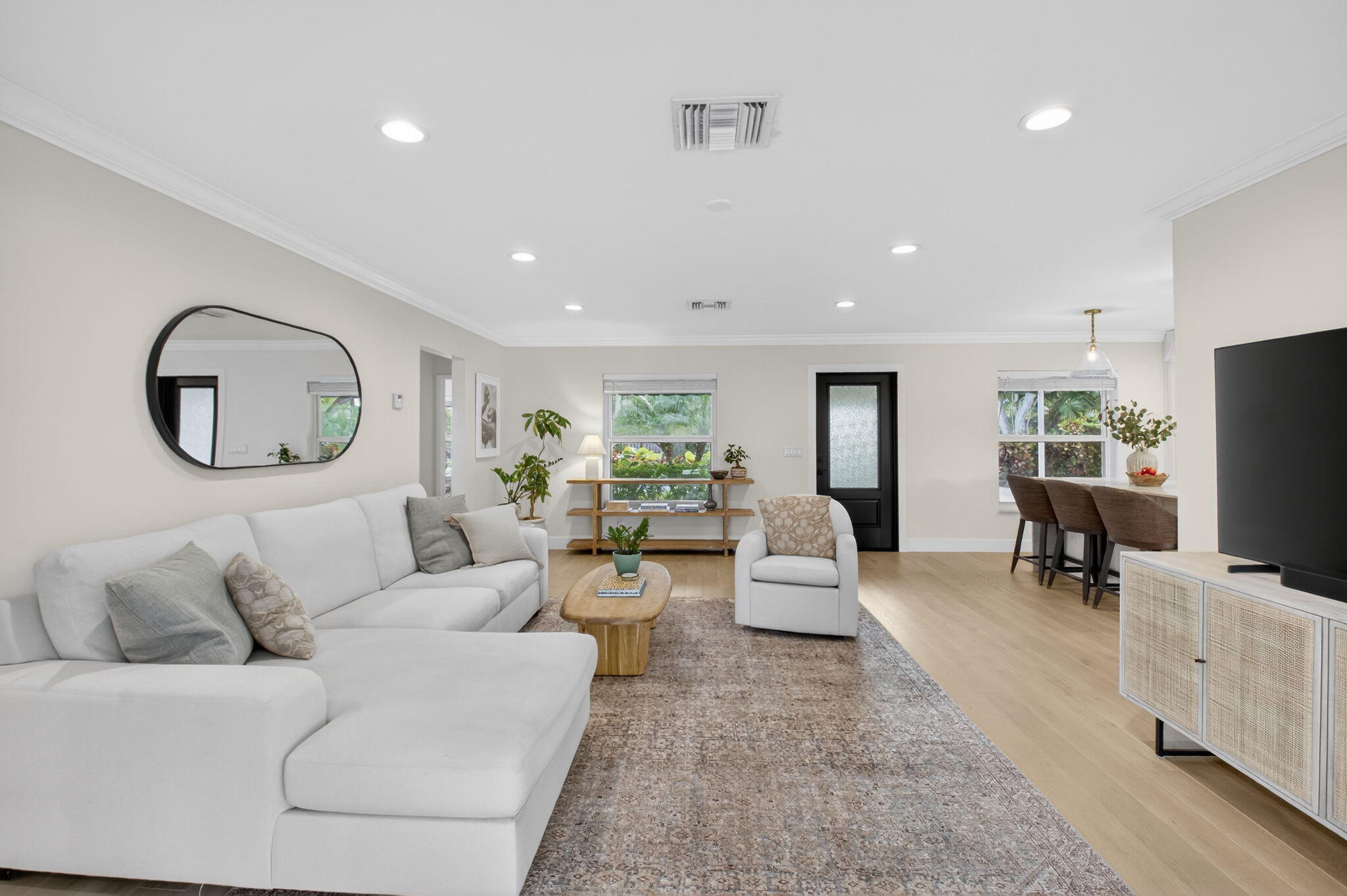 525 Sunset Road Boynton Beach, FL 33435 - Photo 28 of 62 a living room with furniture a mirror and a flat screen tv