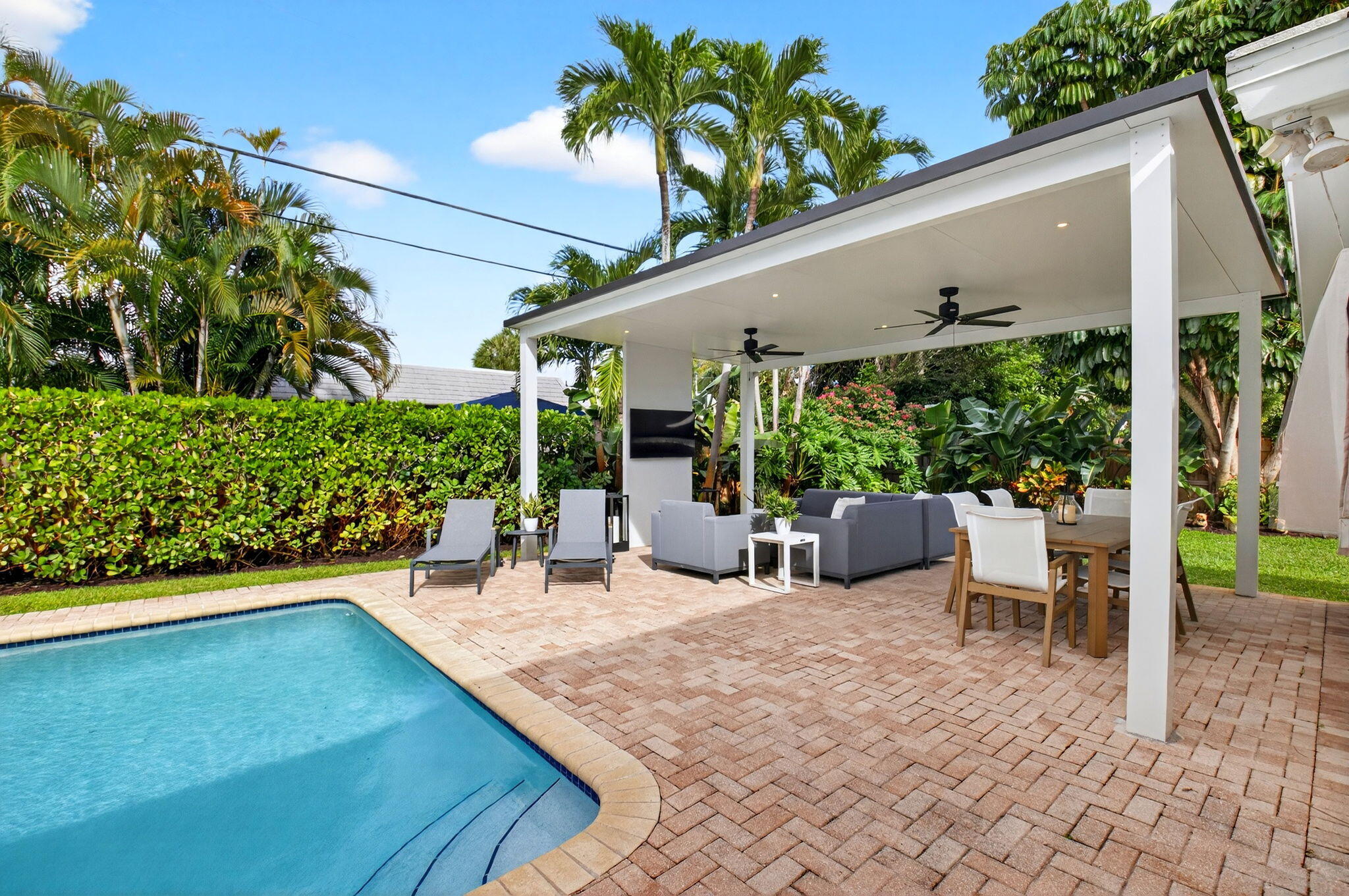 525 Sunset Road Boynton Beach, FL 33435 - Photo 45 of 62 a view of a chair and tables in the patio in front of a house